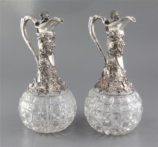 A good pair of Victorian silver mounted cut glass claret jugs by Horace Woodward & Co, 30cm.